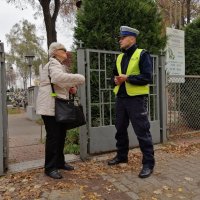 policjant zakłada odblask kobiecie