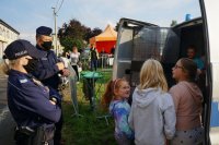 policjanci z dziećmi z tyłu radiowozu