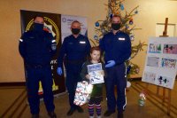 zdjęcie grupowe policjantów z dziewczynką obok choinki