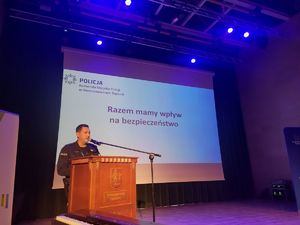 policjant na scenie, za nim slajd Razem mamy wpływ na bezpieczeństwo