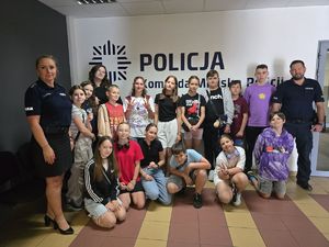 na zdjęciu zdjęcie grupowe policjantów z dziećmi w komendzie