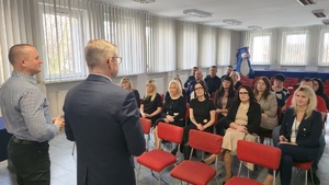 Zdjęcie przedstawia pracowników cywilnych wraz z funkcjonariuszami Policji, którzy słuchają przemówienia Komendanta Miejskiego Policji w Siemianowicach Śląskich