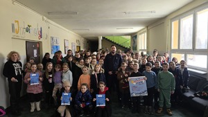 Zdjęcie przedstawia policjanta wraz z dziećmi, którzy pozują do zdjęcia.