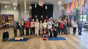 Zdjęcie przedstawia młodzież wraz z gośćmi, którzy pozują do wspólnego zdjęcia